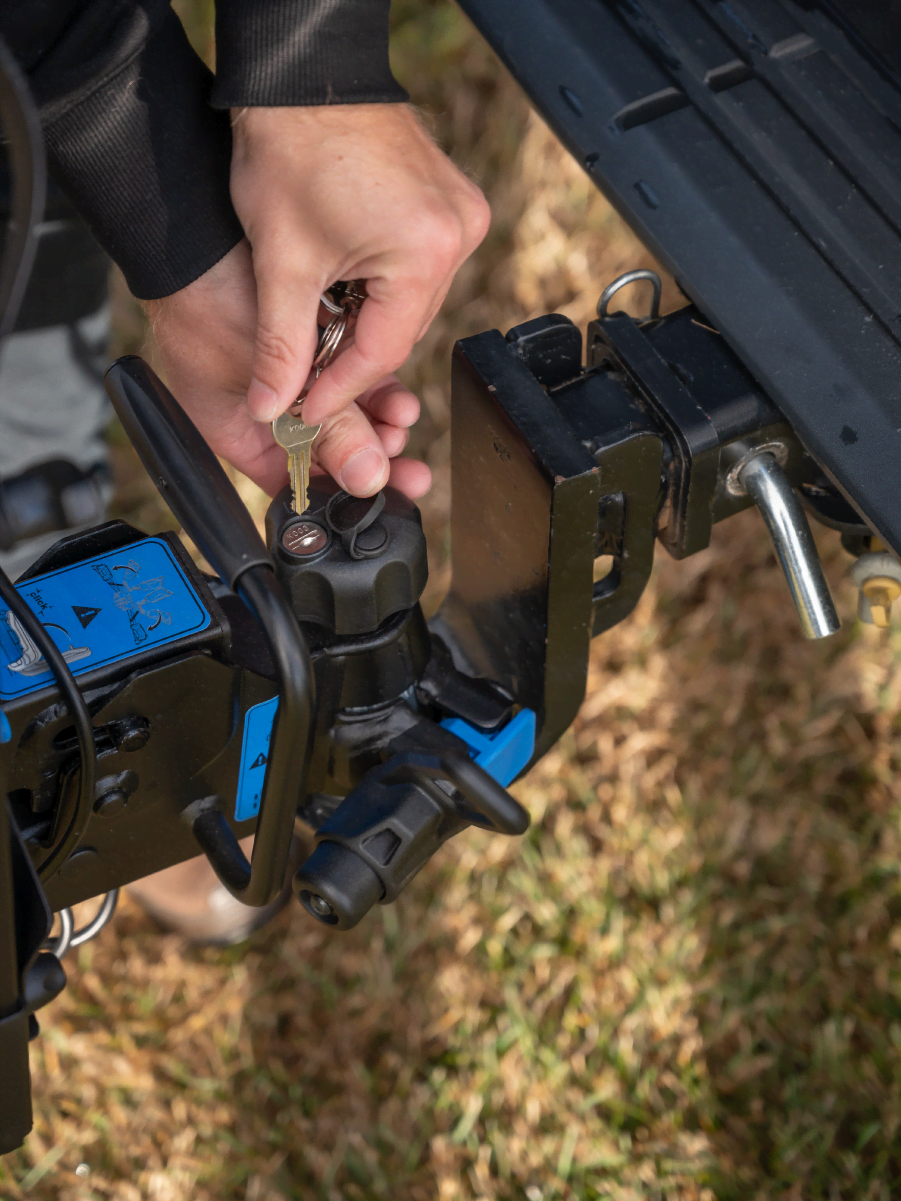 A close up view of a hand locking the tow ball mount of the Ezigrip E-Rack 2 Pro bike rack
