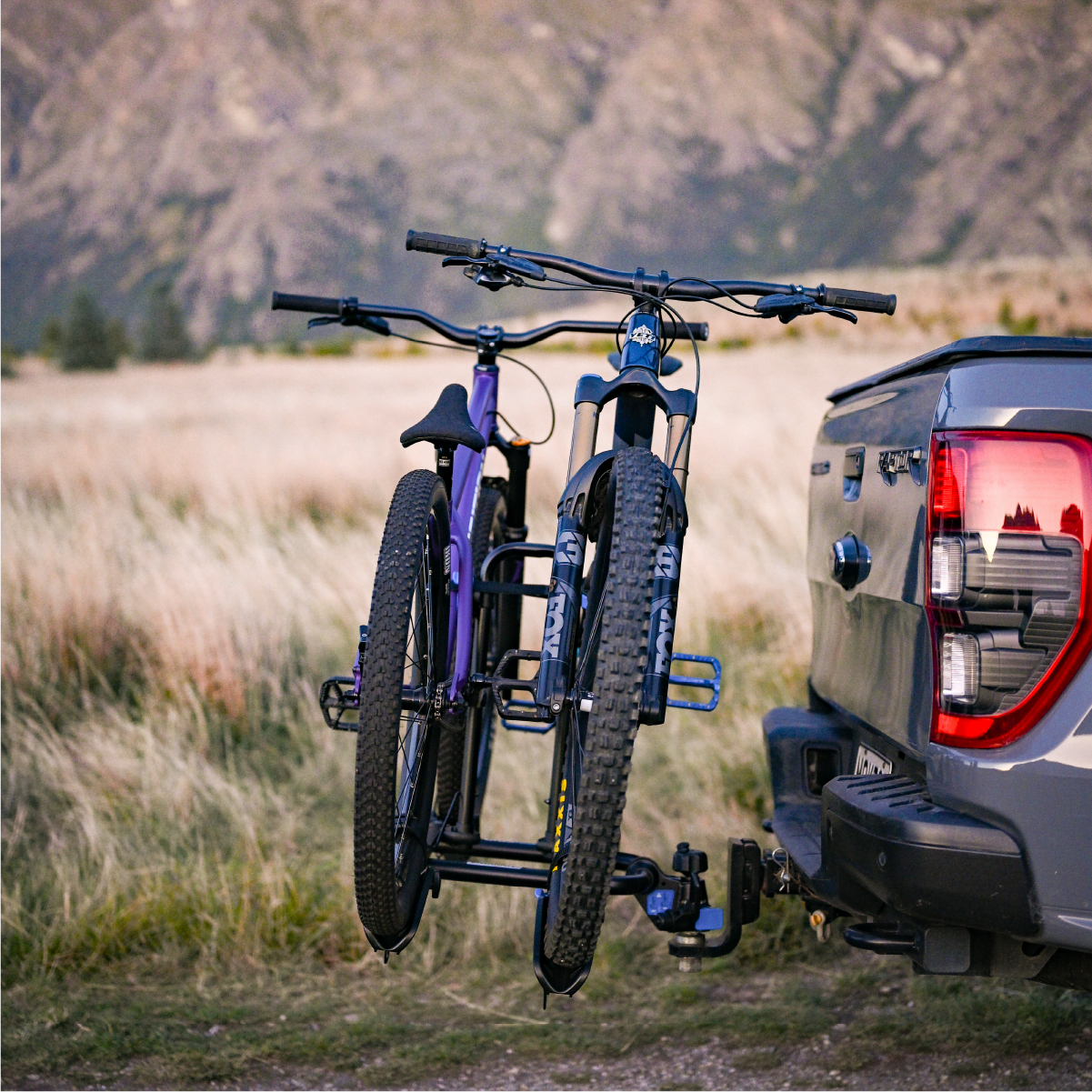 A side view of the Ezigrip Enduro 2 bike rack on the back of a ute with two bikes loaded showing the spacing between bikes