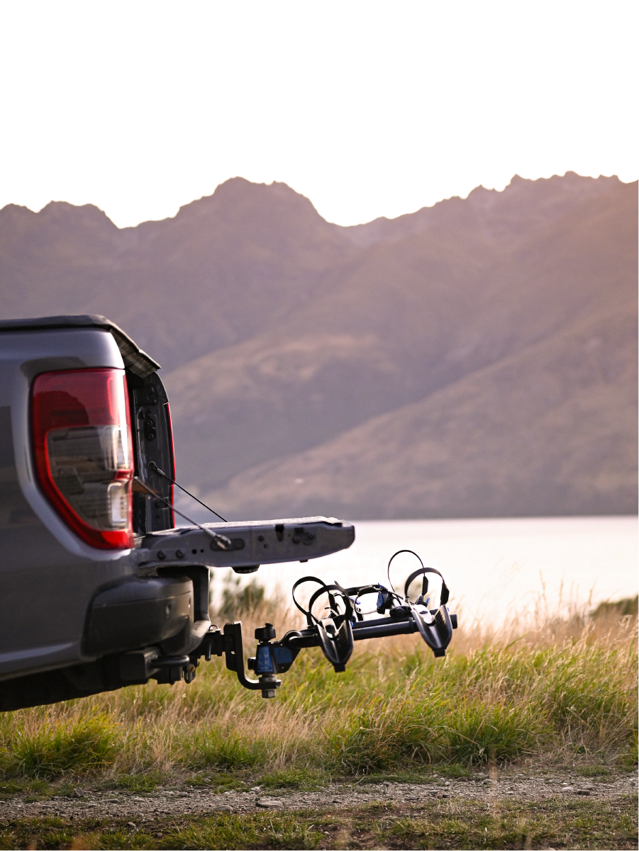 A side view of the Ezigrip Enduro 2 bike rack with the upright folded down and the tailgate of a ute open