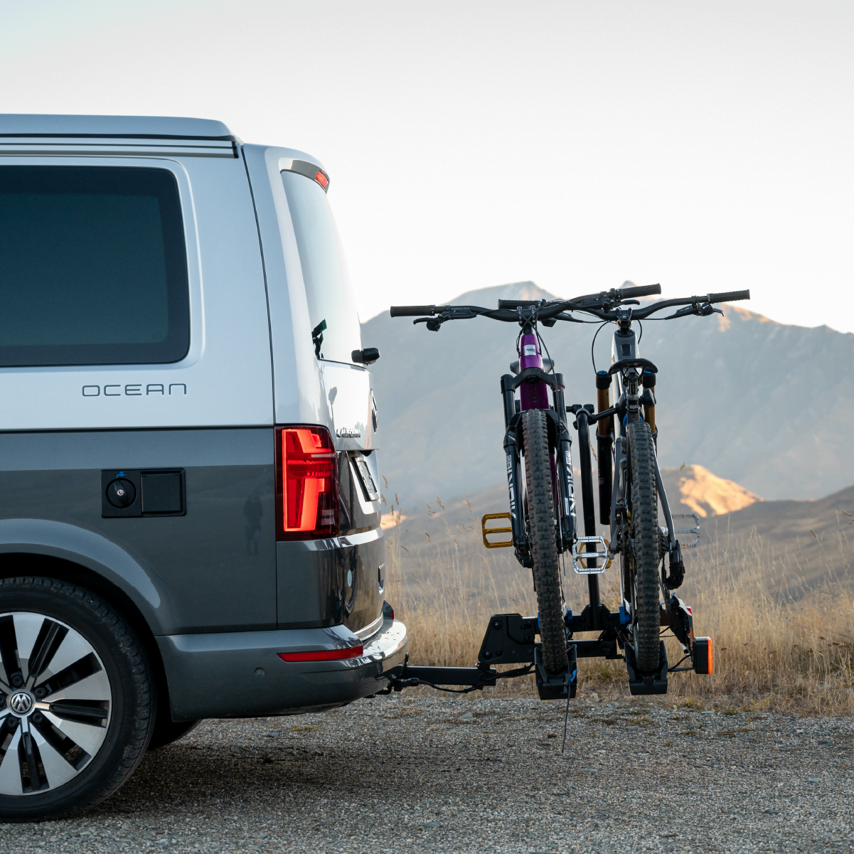 A side on view of the hitch mounted Ezigrip E-Rack 2 Pro bike rack mounted to the hitch of a van and the clearance between van and ebikes is clearly visible.