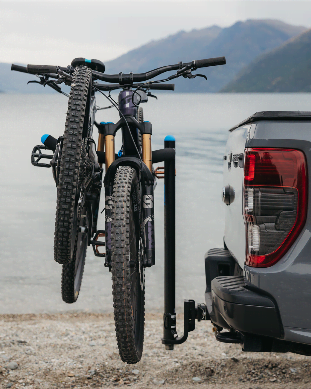 An Advantage 2 prong bike rack is mounted to a ute with two mountain bikes strapped to the prongs