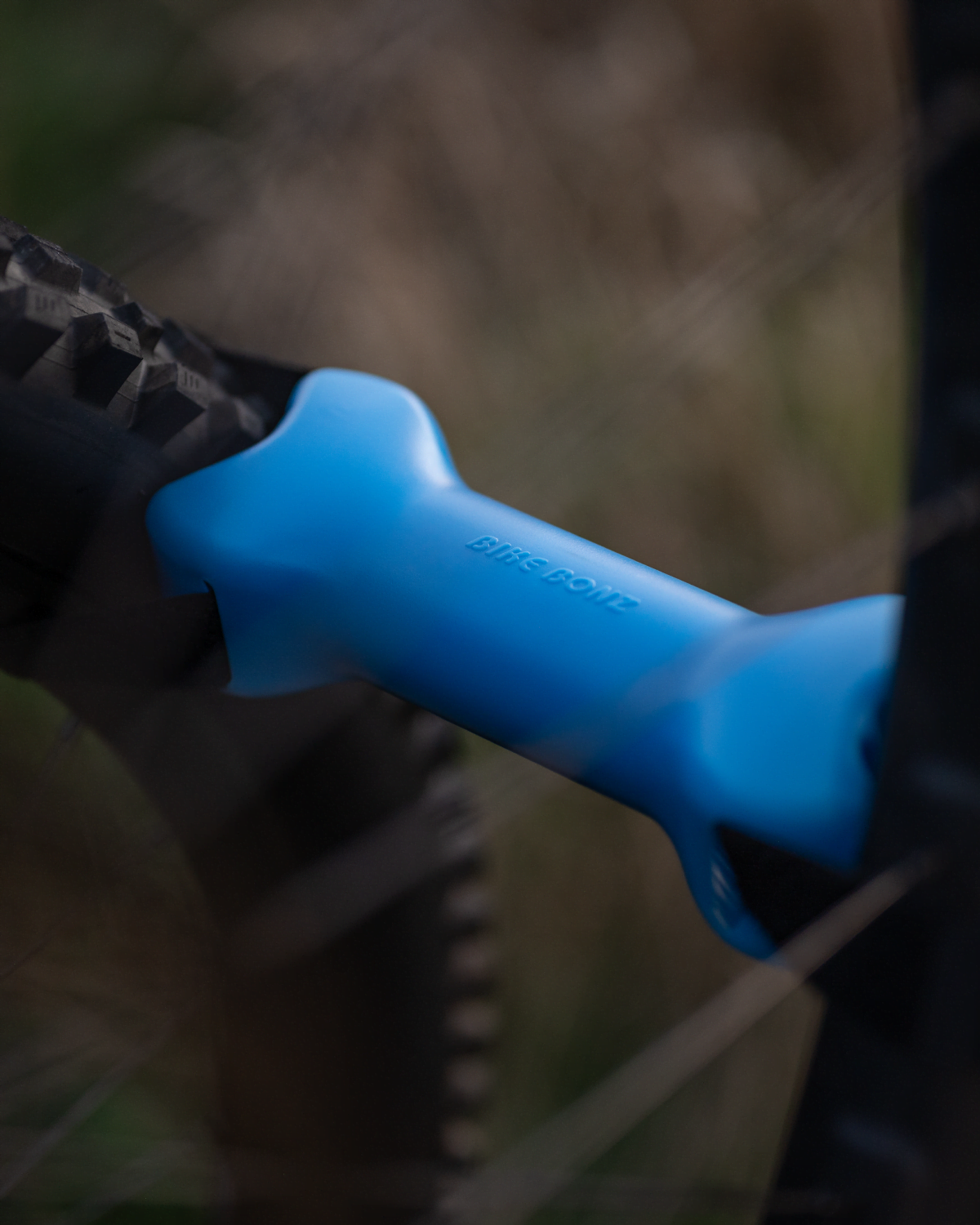 A close view of a bike bone strapped between two bike tires keeping them separated