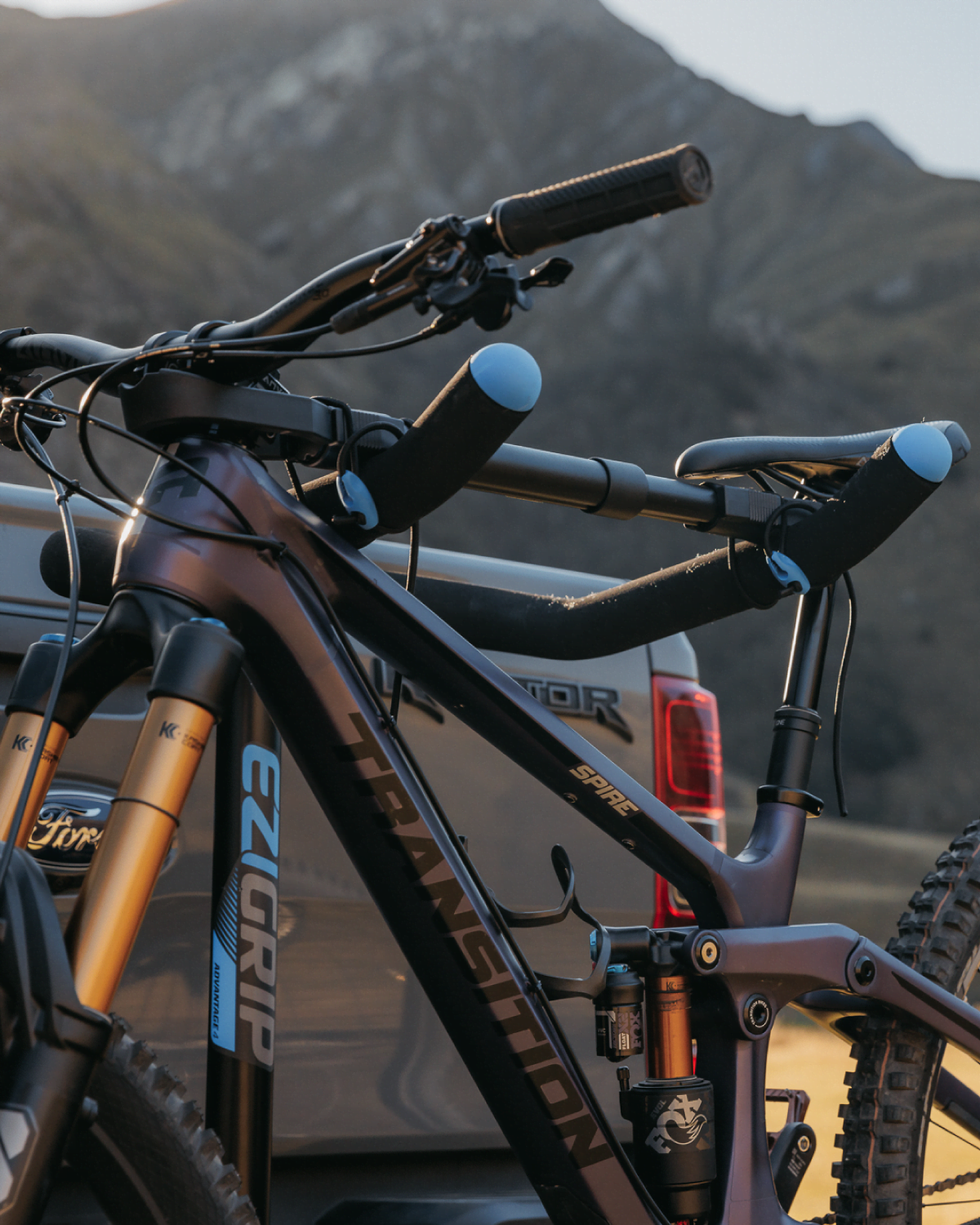 A close view of a bike buddy being used as a top tube of a mountain bike that is strapped to a Advantage prong bike rack