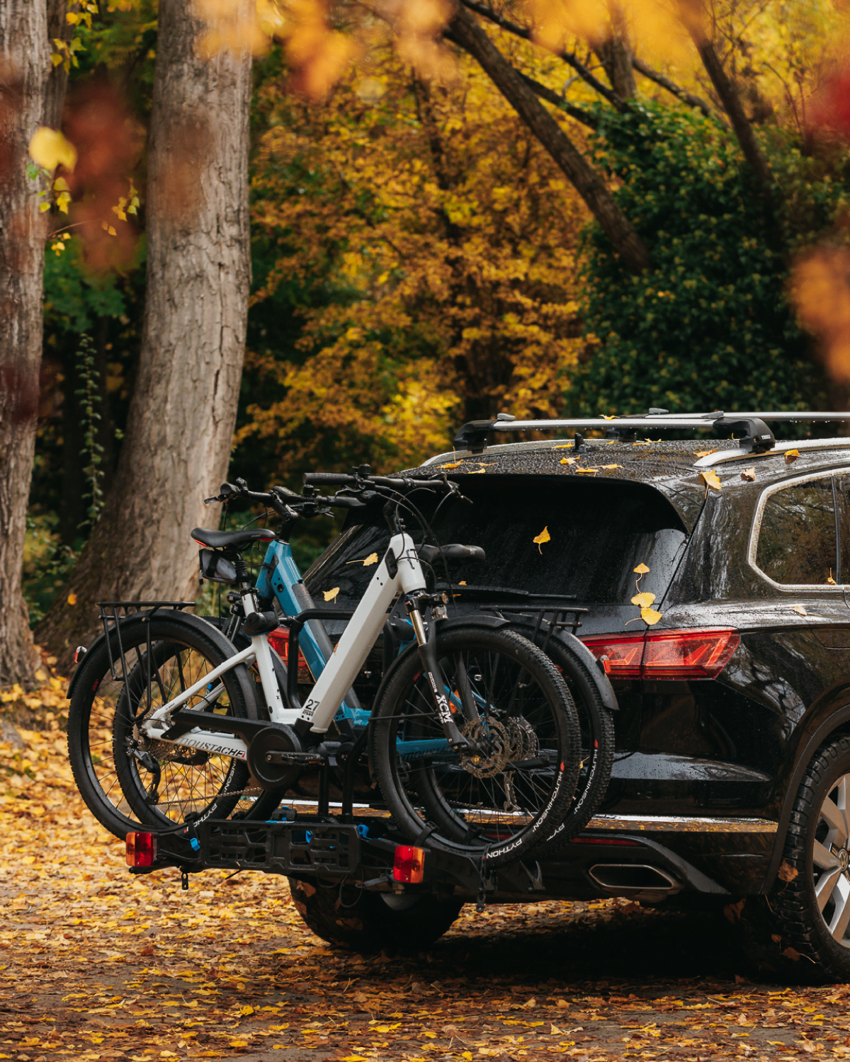 A view of an Ezigrip E-Rack 2 bike rack on the back of an SUV with 2 electric step through bikes loaded on the bike rack