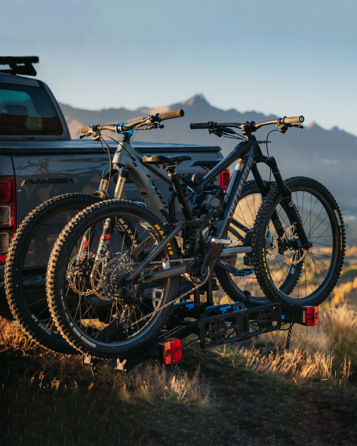 A view of an Ezigrip E-Rack 2 bike rack on the back of an ute with 2 electric mtbs loaded on the bike rack