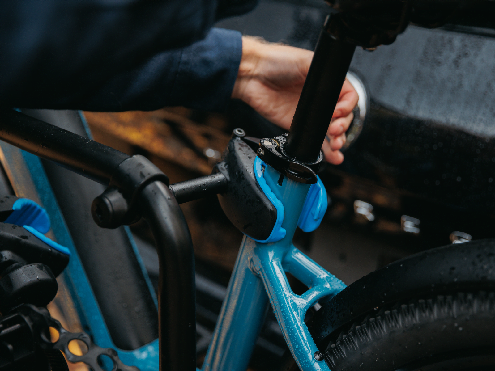 A close view of a man installing an Ezigrip Frame Clamp on a step-through electric bike on the E-Rack 2 Bike rack