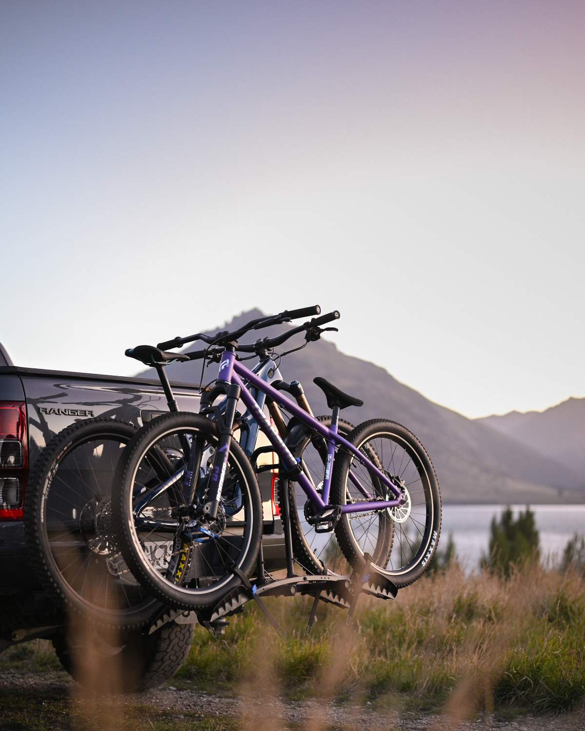 An Enduro 2 bike rack is mounted to a ute with two mountain bikes strapped to the bike rack with generous spacing clearly visible between the bikes