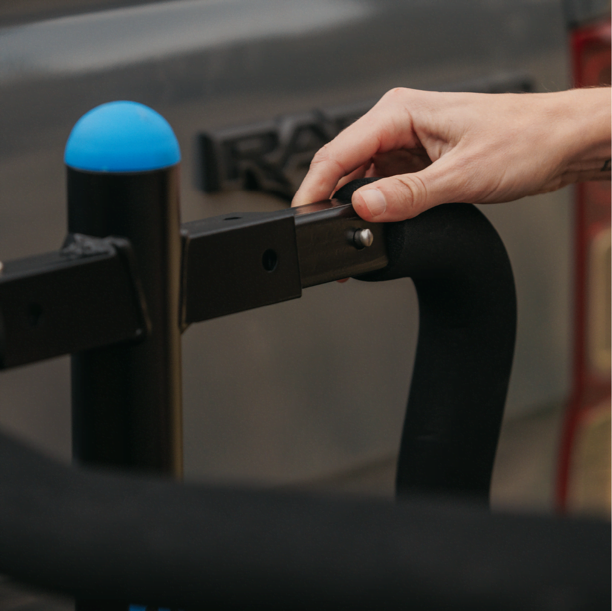 A woman is removing the arms of the Advantage 2 bike rack