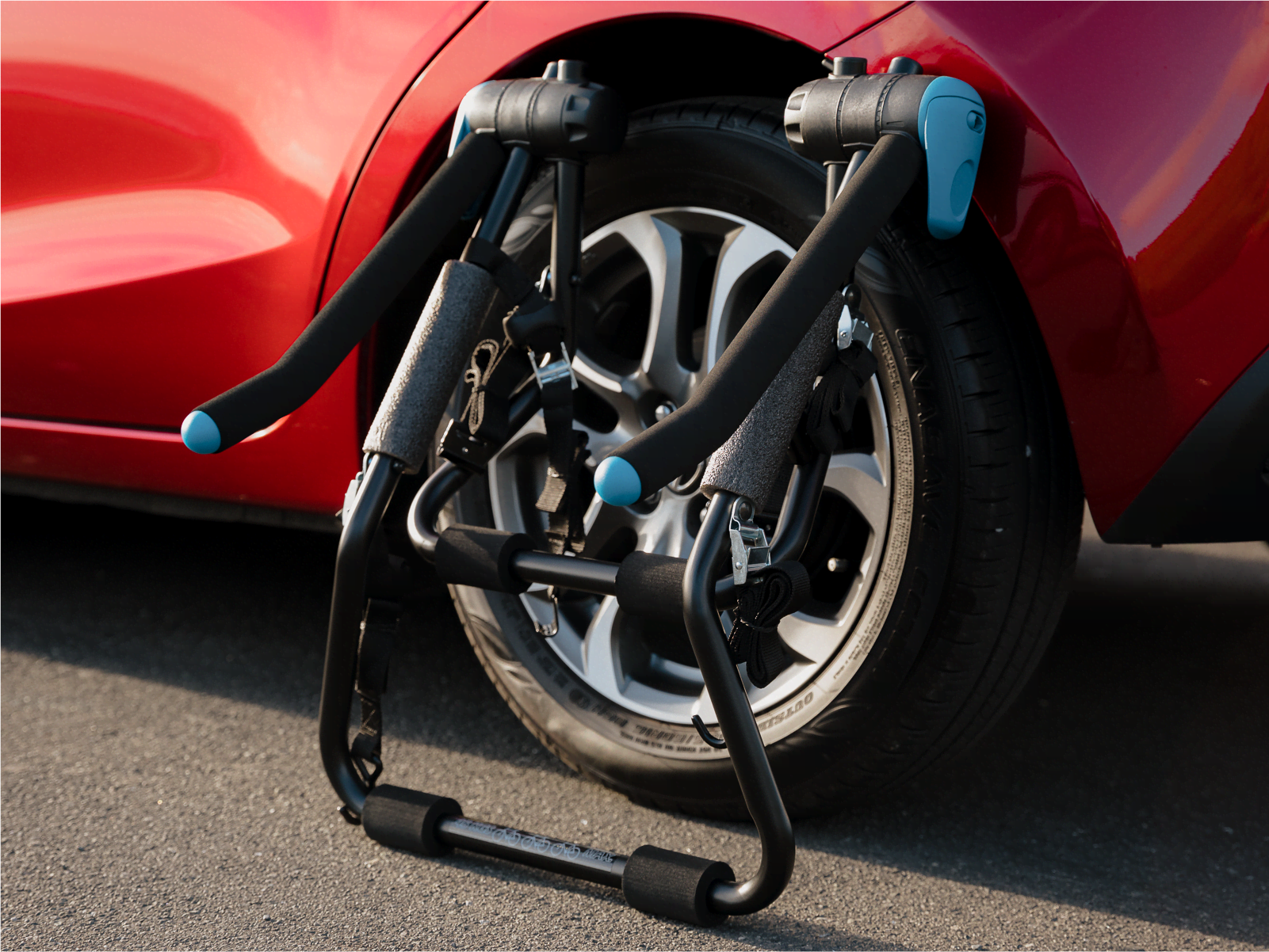 A bootmount 3 pro bike rack is folded neatly resting against a vehicle