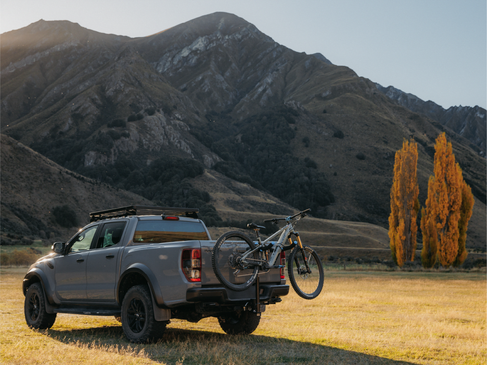 An electric bike is strapped to an Advantage 2 bike rack with the mountains in the background