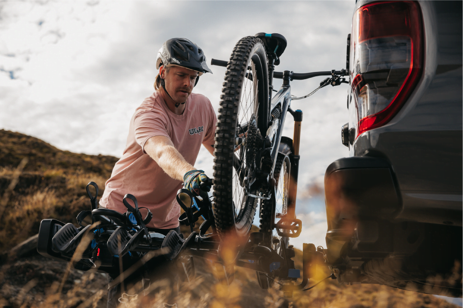 A man is removing a bike from an Ezigrip Enduro 4 bike rack