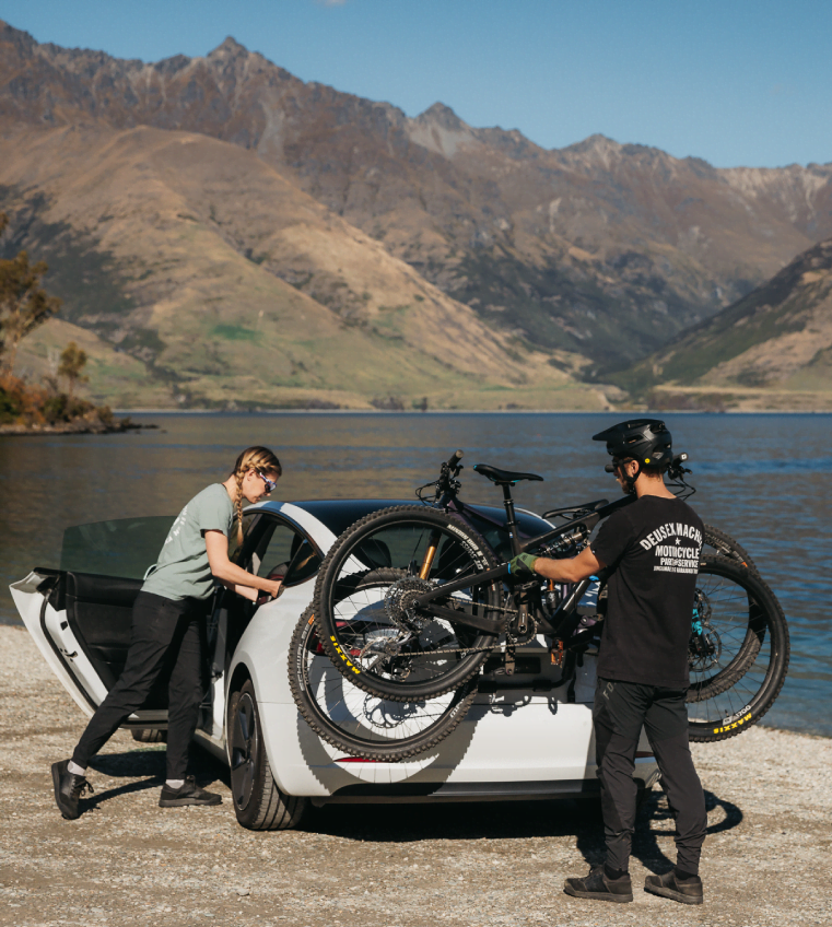 A man is installing a bike onto a Bootmount 3 pro bike rack