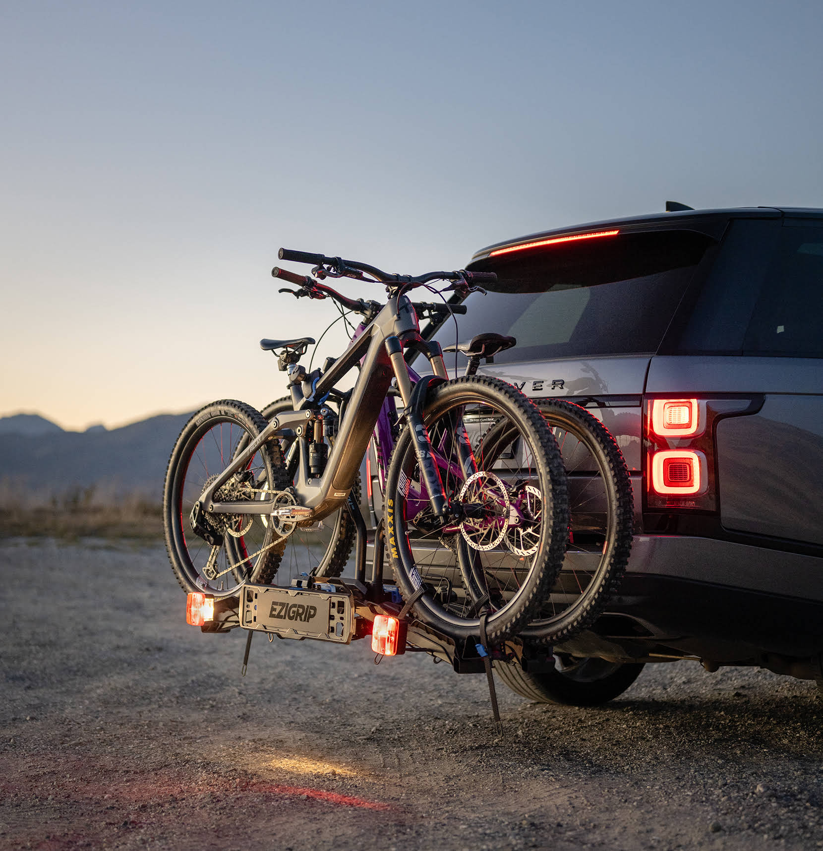 two electric mountain bikes are strapped into an Ezigrip E-Rack 2 Pro bike rack on a Range Rover