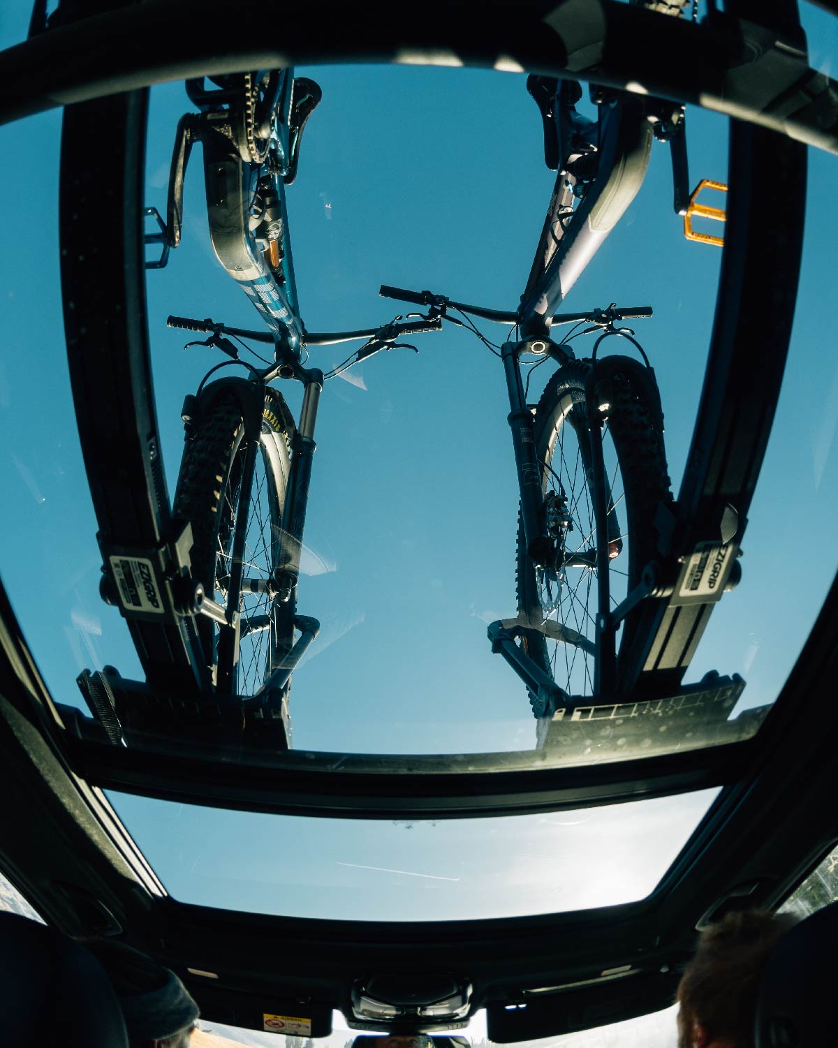 a view through a car panoramic roof of two bikes in an ezigrip uplift 1