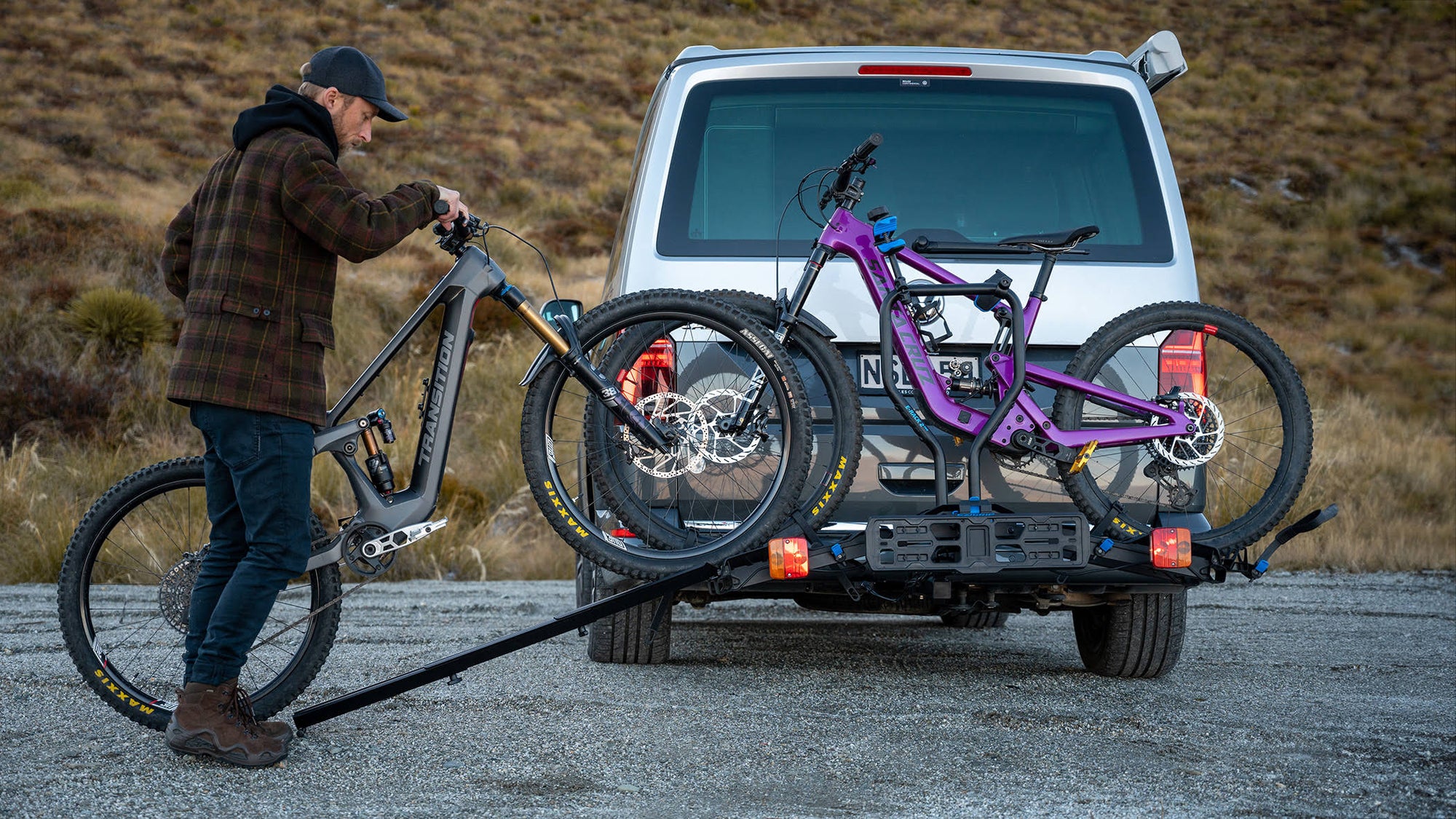 A man rolls an ebike up onto an Ezigrip E-Rack 2 Pro bike rack