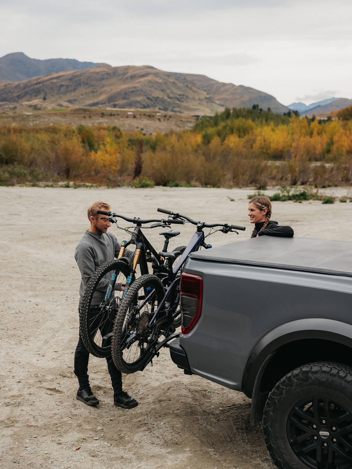 A man is loading a second mountain bike into the Ezigrip Enduro 2 bike rack.